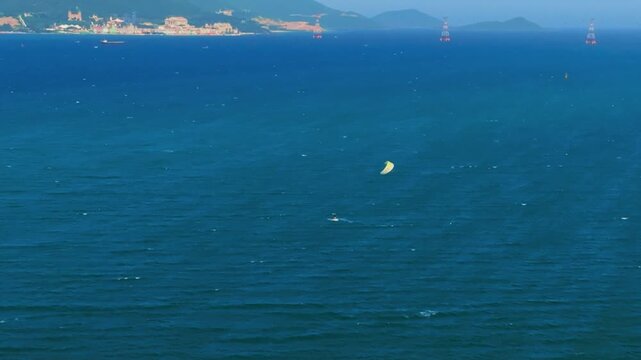 Aerial 4K parasailing adventure over turquoise ocean in Nha Trang Vietnam
the thrill of extreme water sports, the vibrant colors of the parachute, and the white wake of the boat against the blue sea