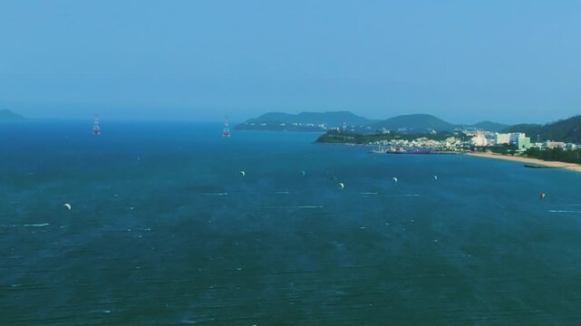 Aerial 4K parasailing adventure over turquoise ocean in Nha Trang Vietnam
the thrill of extreme water sports, the vibrant colors of the parachute, and the white wake of the boat against the blue sea