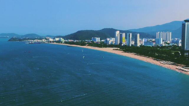 Aerial 4K parasailing adventure over turquoise ocean in Nha Trang Vietnam
the thrill of extreme water sports, the vibrant colors of the parachute, and the white wake of the boat against the blue sea