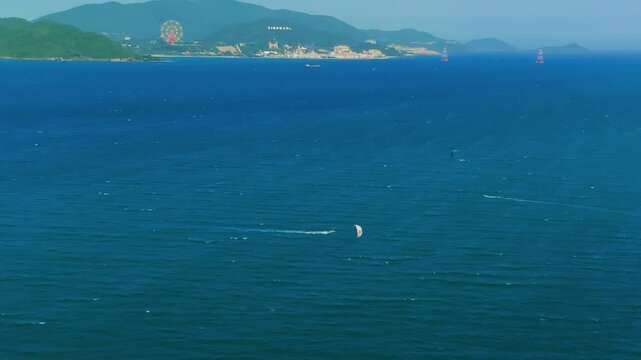 Aerial 4K parasailing adventure over turquoise ocean in Nha Trang Vietnam
the thrill of extreme water sports, the vibrant colors of the parachute, and the white wake of the boat against the blue sea