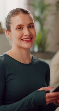 Phone, break and face of woman in home for exercise with reading fitness blog for tips or advice on app. Happy, portrait and female person with cellphone for relax with online workout in living room.