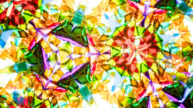Macro photography of a natural kaleidoscope pattern captured on camera. Vivid red, green, blue, yellow, and orange tones. Ideal for abstract backgrounds, web design, and textile prints.