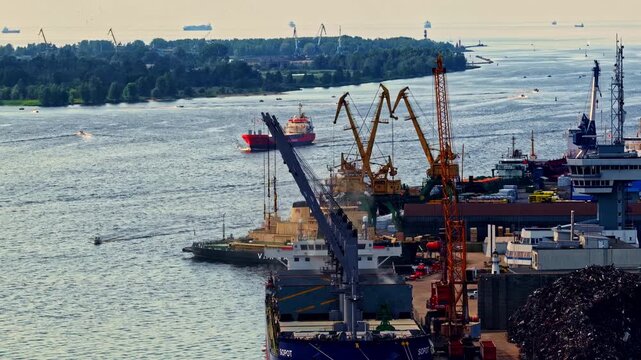 Busy port with ships, cranes, and river
