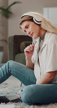 Lounge, headphones and woman with laptop, elearning and planning for assignment with research on web. Student, music and person with tech for exam preparation, reflection and online education in home