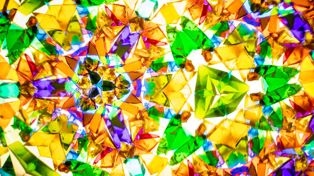 Macro photography of a natural kaleidoscope pattern captured on camera. Vivid red, green, blue, yellow, and orange tones. Ideal for abstract backgrounds, web design, and textile prints.