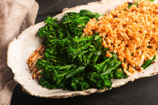 Blanched Bimi Broccoli with Toasted Almonds, Butter and Breadcrumbs on Handmade Ceramic Plate