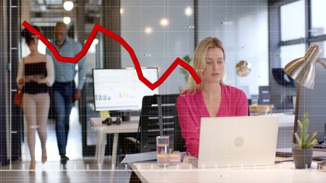 Seated woman working laptop in business, input driving red chart crossing torso as coworkers pass