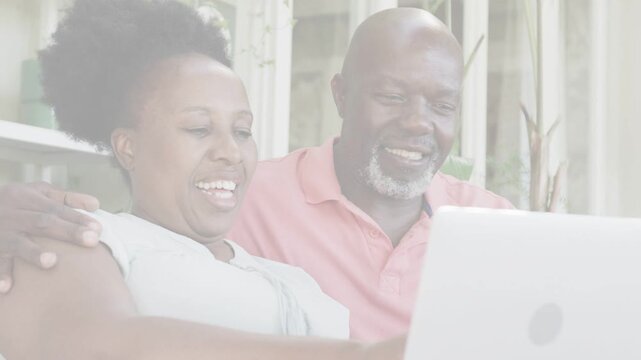 Mature woman typing on laptop older man leaning in overlay fading couple bonding over tech content