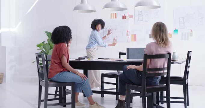 Diverse coworkers watching designer grabbing swatches, arranging wall in white studio for approval