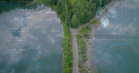 Obraz premium Showing narrow wooded land spit with central road running along lakeshore, with circuit overlays
