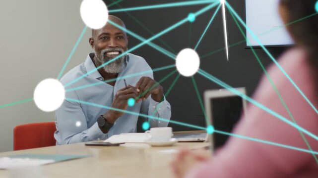 Coworker gesturing sparking node overlay while man leaning, pointing pen, showing business data