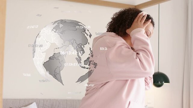 Woman putting on headphones near bed, starting music tech demo, globe overlaying and she swaying