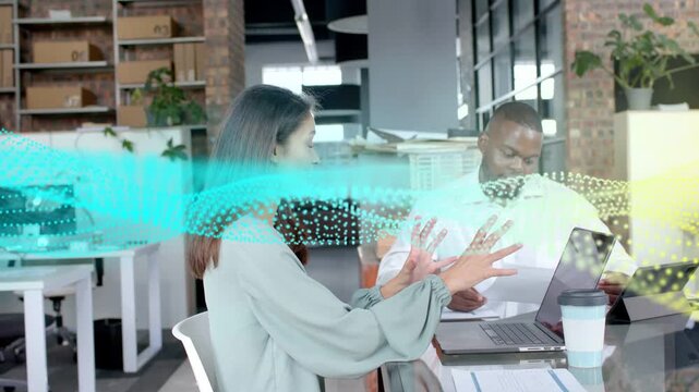 Woman explaining, gesturing, man reading docs, glancing laptop, work dot wave flowing through hands