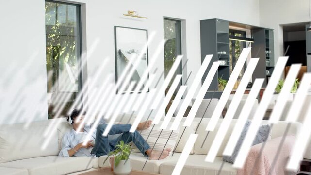 Man lounging on sofa tapping device, overlay sweeping left, obscuring man then revealing home tech