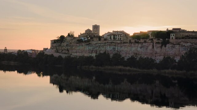 Scenic sunset over the ancient city of Zamora reflecting in the calm waters of the Duero river in Spain