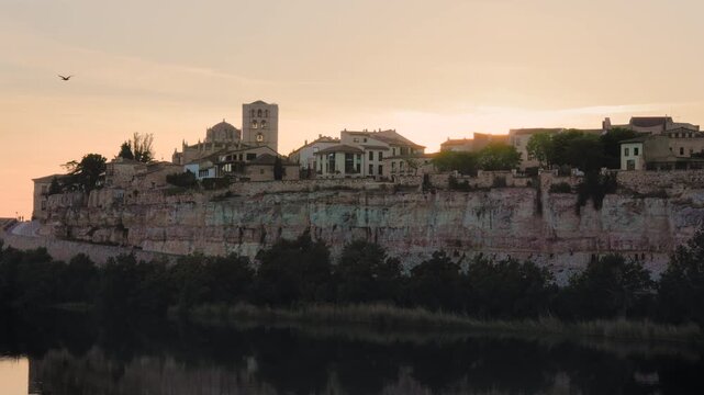 Medieval spanish city of Zamora sitting on a cliff overlooking the Douro river during a beautiful golden sunset