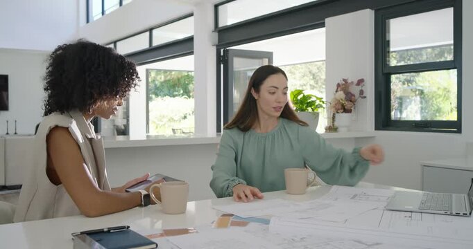 Diverse female team in studio right flipping plans left using tablet and laptop finalizing plan