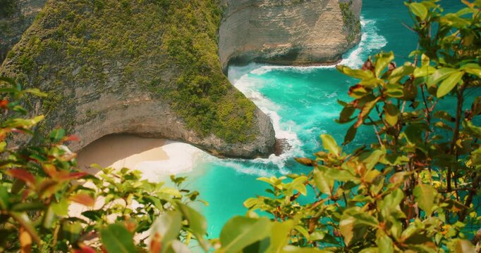 Pristine sand and turquoise ocean waves at Kelingking Beach Nusa Penida coastal view