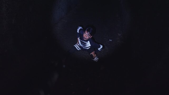 Top-Down View of a Possessed Man in a Dark Pit