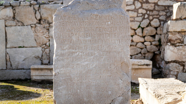 Ancient Greek inscription carved into a stone slab at the Patara archaeological site, Antalya, Turkey