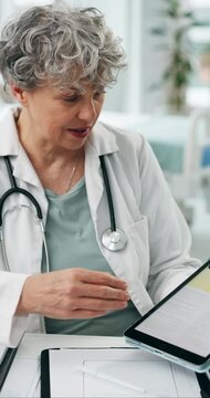 Hospital, talking and mature doctor on tablet for consulting, advice and research for treatment. Healthcare, screen and woman on tech for medical service, website and report for patient diagnosis