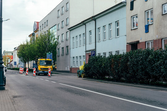 Prostejov, Czech Republic - April 18, 2026: DAF road work truck and Ammann AV33-2 roller on urban street repair site, ulice Olomoucka