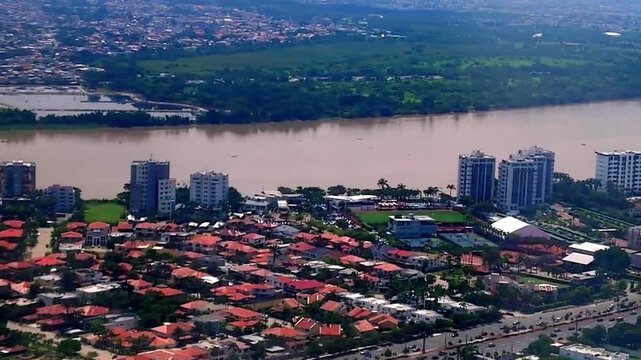 From the airplane window, the city of Guayaquil and the Guayas River are visible just minutes before landing. The scene captures the urban landscape and natural beauty of Ecuador as the aircraft appro