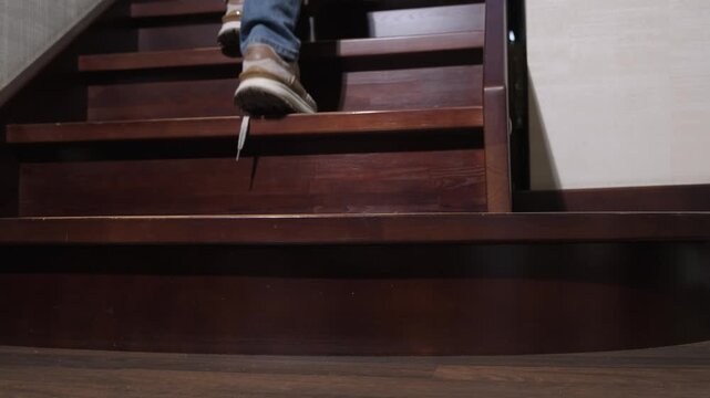 People climb up a wooden ladder with their shoelaces untied at home