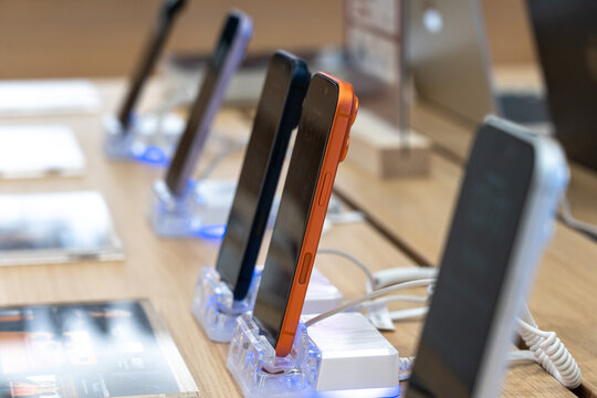 Showcase of Modern Smartphones Displayed on Stands for Customer Examination in a Retail Environment