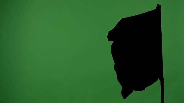 Black flag on a pole against a green background with alpha channel. Concept of symbol, protest, warning, anonymity, and chroma key element for video editing and design.