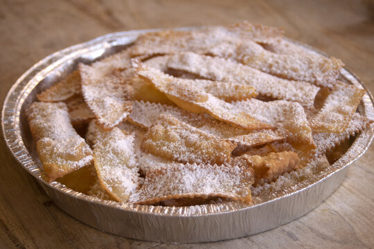 Traditional Italian Chiacchiere Pastry with Powdered Sugar in Tray