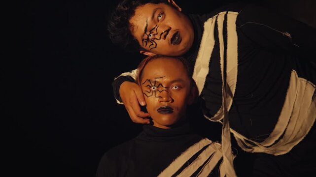 Two Male Performers with Dramatic Spider Makeup