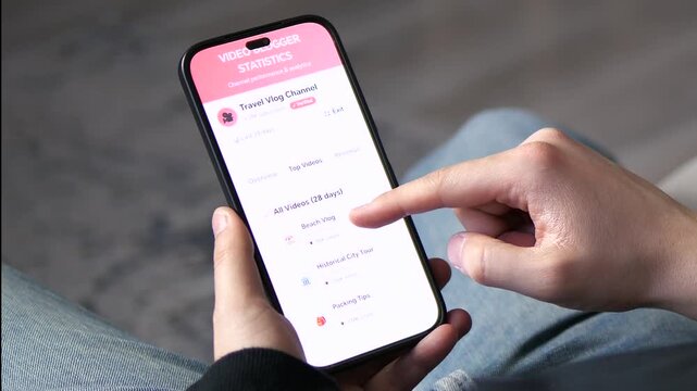 Close-up of blogger scrolling through channel performance and video statistics. High-quality UI showing views, watch time, and income data. Ideal for content creation, data analysis, and online