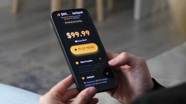 User plays an online mobile lottery app. Hands holding a phone showing a big jackpot and Play Now button. Ideal for gambling, gaming, and digital entertainment themes. Smooth UI or UX display. High