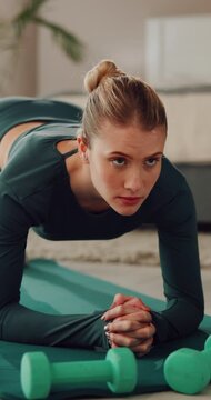 Fitness, plank and woman on floor in home for pilates, wellness and core strength with weights. House, muscles and person on exercise mat for workout, training or active hobby for balance and health