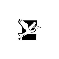 Obraz premium Monochrome vector logo of a flying crane set against an alphabet letter E background, perfect for modern branding, logo identity, minimalist emblem, and graphic design.
