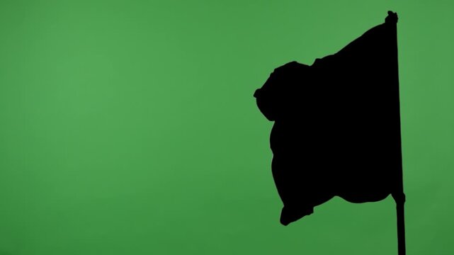 Black flag on a pole against a green background with alpha channel. Concept of symbol, protest, warning, anonymity, and chroma key element for video editing and design.