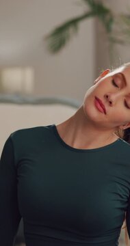 Stretching, neck and woman in home, fitness and exercise for warm up, relax and routine. Apartment, athlete and person in living room, training and workout for stress relief and health benefits