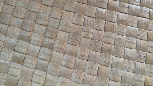 Close-up of a handmade woven seagrass mat with unique natural imperfections. A versatile, breathable, and earthy addition to any sustainable living space decor.