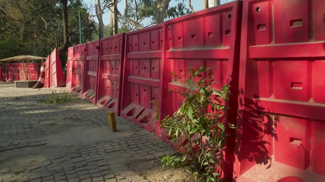 Red metal construction barricades lined up on city street