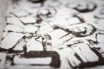 Naklejka premium Extreme close up of black acrylic paint texture on paper. Selective focus.