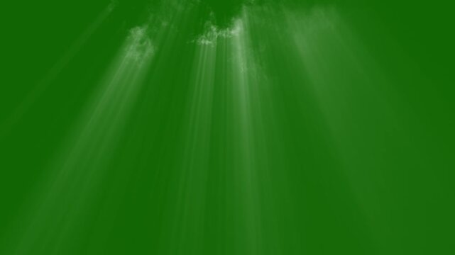 Light rays leaking from above shining through moving smoke, isolated on green screen. Light leak from above through moving smoke. Rays of light through drifting smoke. green green