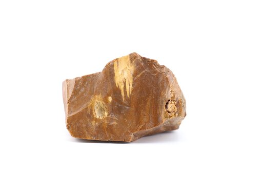 Raw brown flint, also known as flintstone, chert, or firestone. It's a type of microcrystalline quartz. White background.