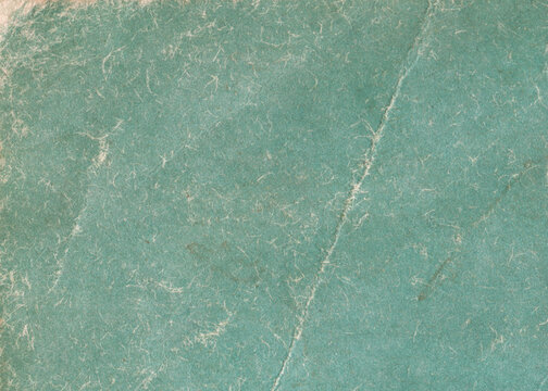 Grunge frayed green paper background. Texture of vintage paper.