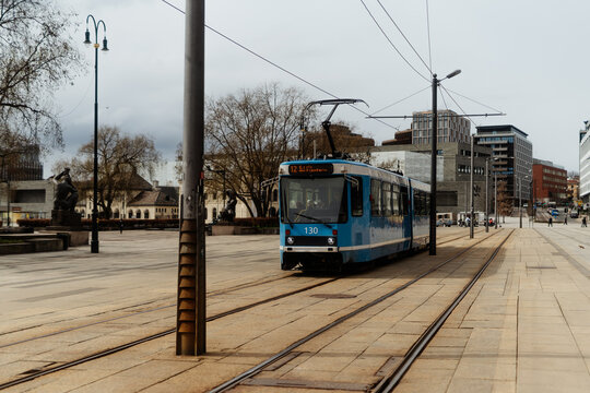 Blue Tram Driving on City Street in Oslo Norway