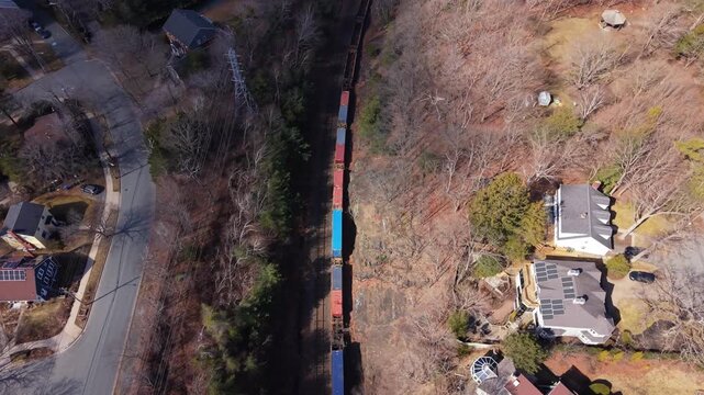Top View Freight Train Carrying Containers From Port Of Halifax Nova Scotia Canada Moving Under Bridge Over Rocky Channel Toward United States Busy Railway Industrial Logistics Scene