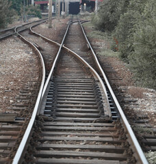 Obraz premium Railway track with switch and interchange and high rise building in Belgrade city Serbia Railway track in the evening in sunset View of the crossing railway in sunset in summer.