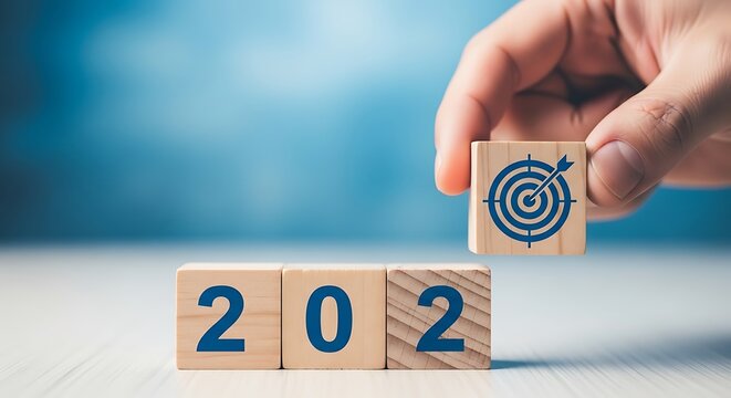Hand placing a target block on top of 202 blocks for goal setting
