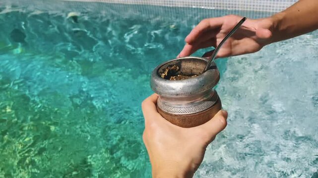 Sharing Traditional Mate Drink With Friends in the Pool a Warm Summer Day in Argentina