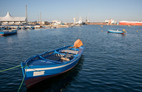 A small blue fishing vessel in Tripoli harbor, Libya, North Africa.